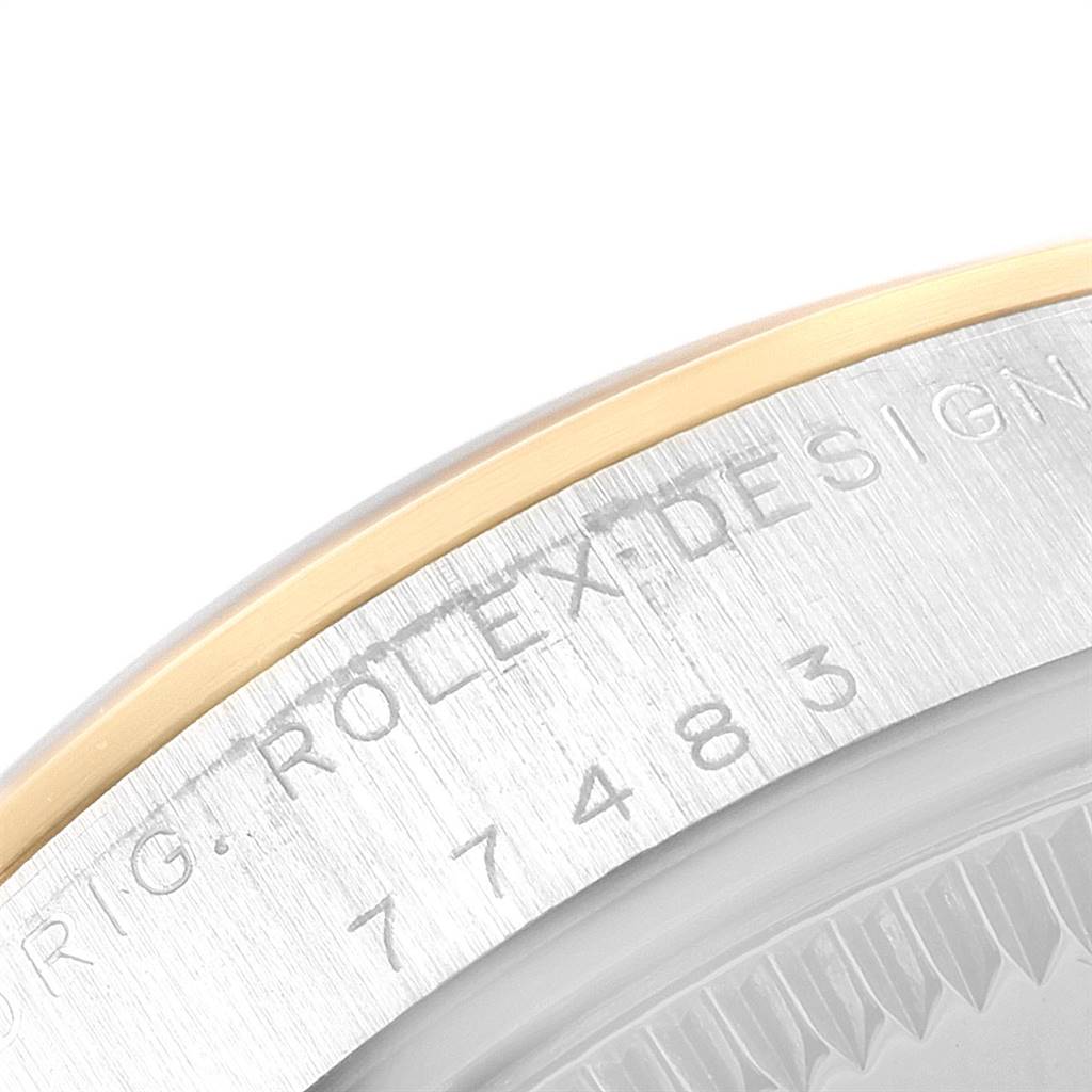 This image shows a close-up of the side engraving and bezel of a Rolex Mid-Size 20548 Women
s Steel and Gold (two tone) Champagne Dial 20548 Women
s Steel and Gold (two tone) Champagne Dial model watch.