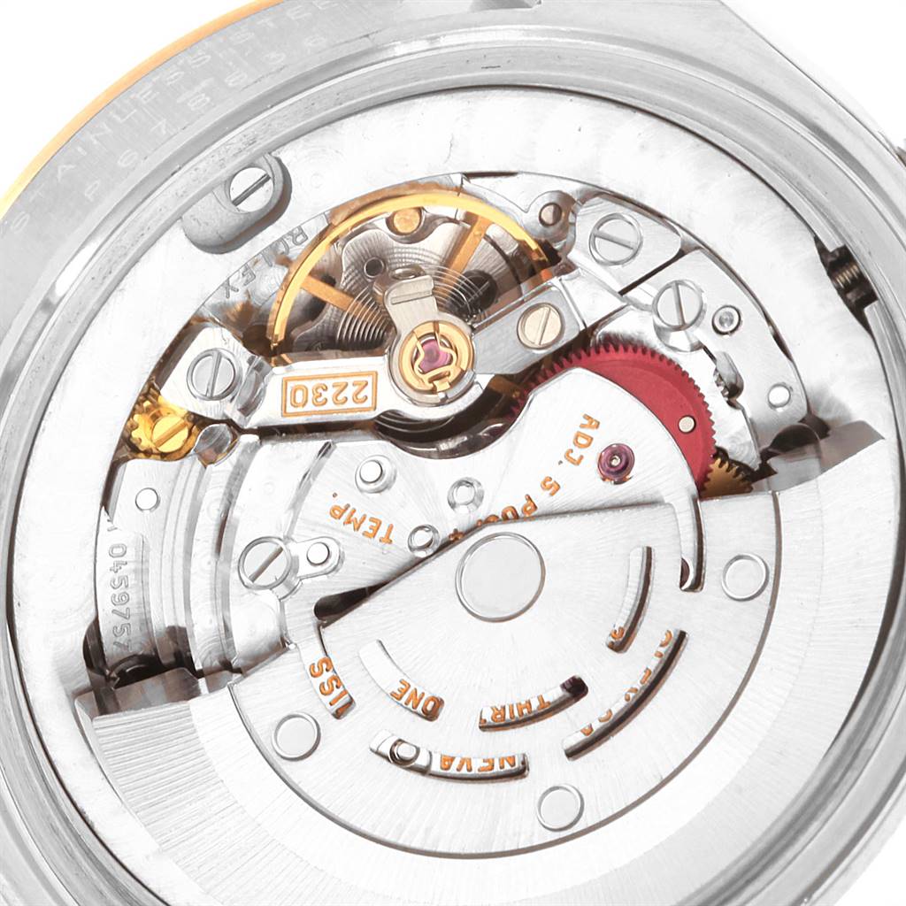 The image shows the internal movement and mechanical parts of a Mid-Size Rolex watch from a close-up angle.