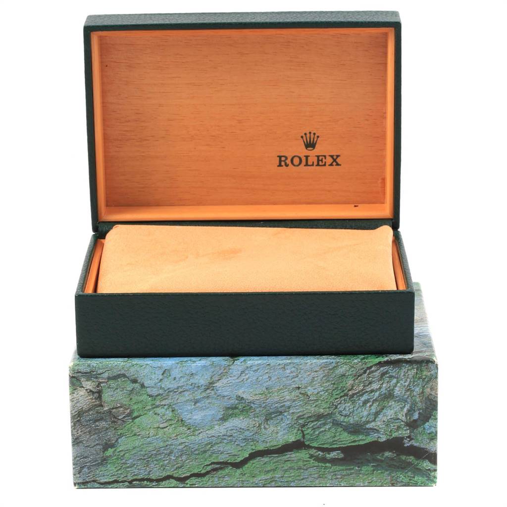 The image shows a Rolex watch box, open, with the interior and branding visible, but no watch inside.