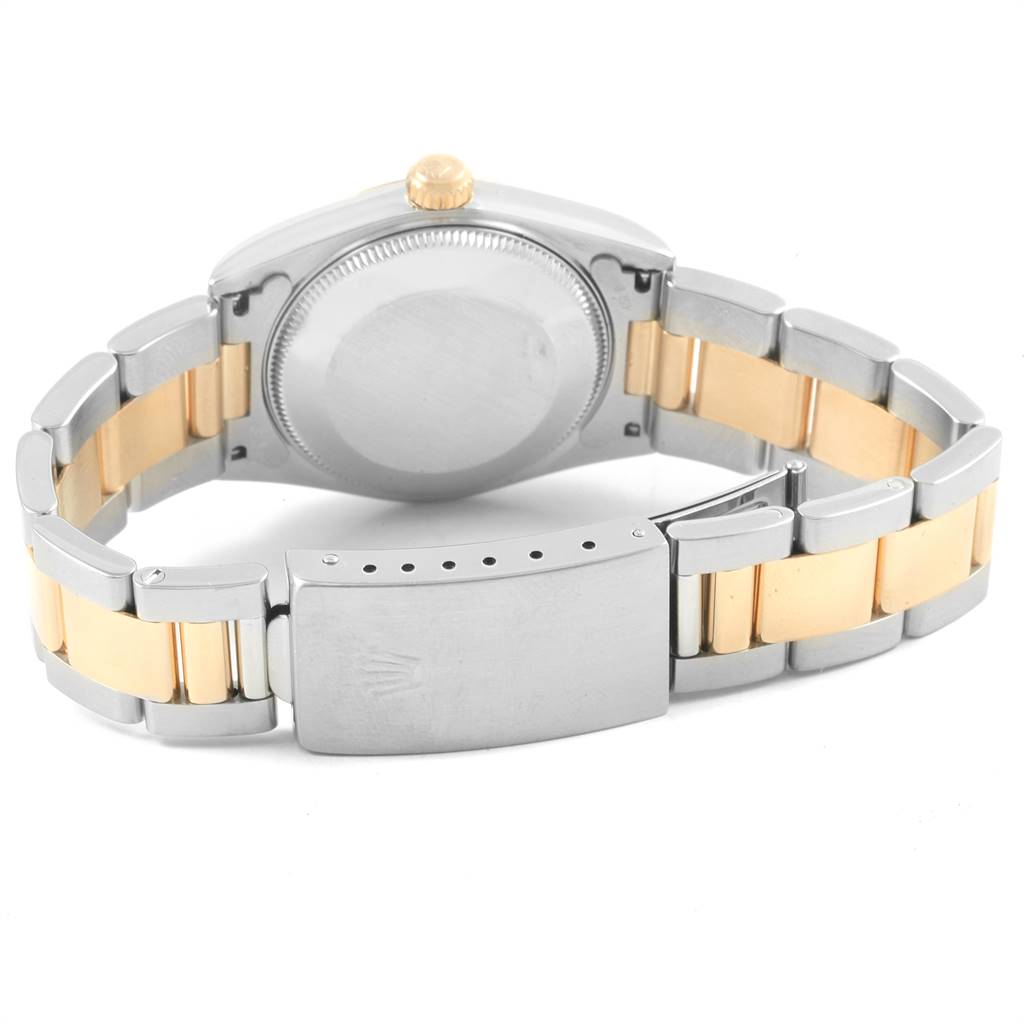 The image shows the back of a Rolex Mid-Size 20548 Women
s Steel and Gold (two tone) Champagne Dial 20548 Women
s Steel and Gold (two tone) Champagne Dial watch, highlighting the case back and two-tone bracelet with the clasp.