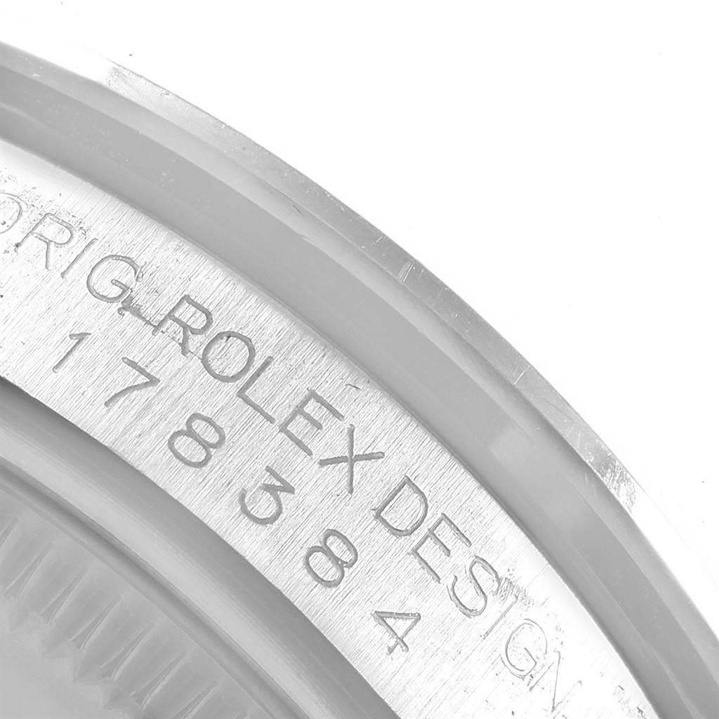 The image shows a close-up of the case engraving on a Mid-Size Rolex watch, focusing on the model and design number.