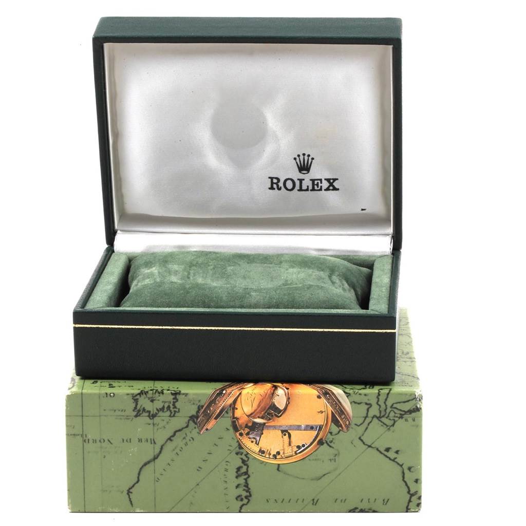 This image shows a green Rolex Mid-Size 68240 Women's Stainless Steel Grey Dial 68240 Women's Stainless Steel Grey Dial watch box partially open, revealing the cushioned interior and the Rolex logo.