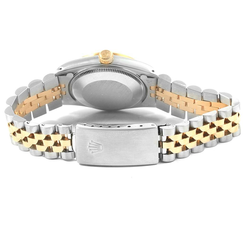 The image shows the back view of a Mid-Size Rolex watch, highlighting the case back, crown, and bi-color metal bracelet.