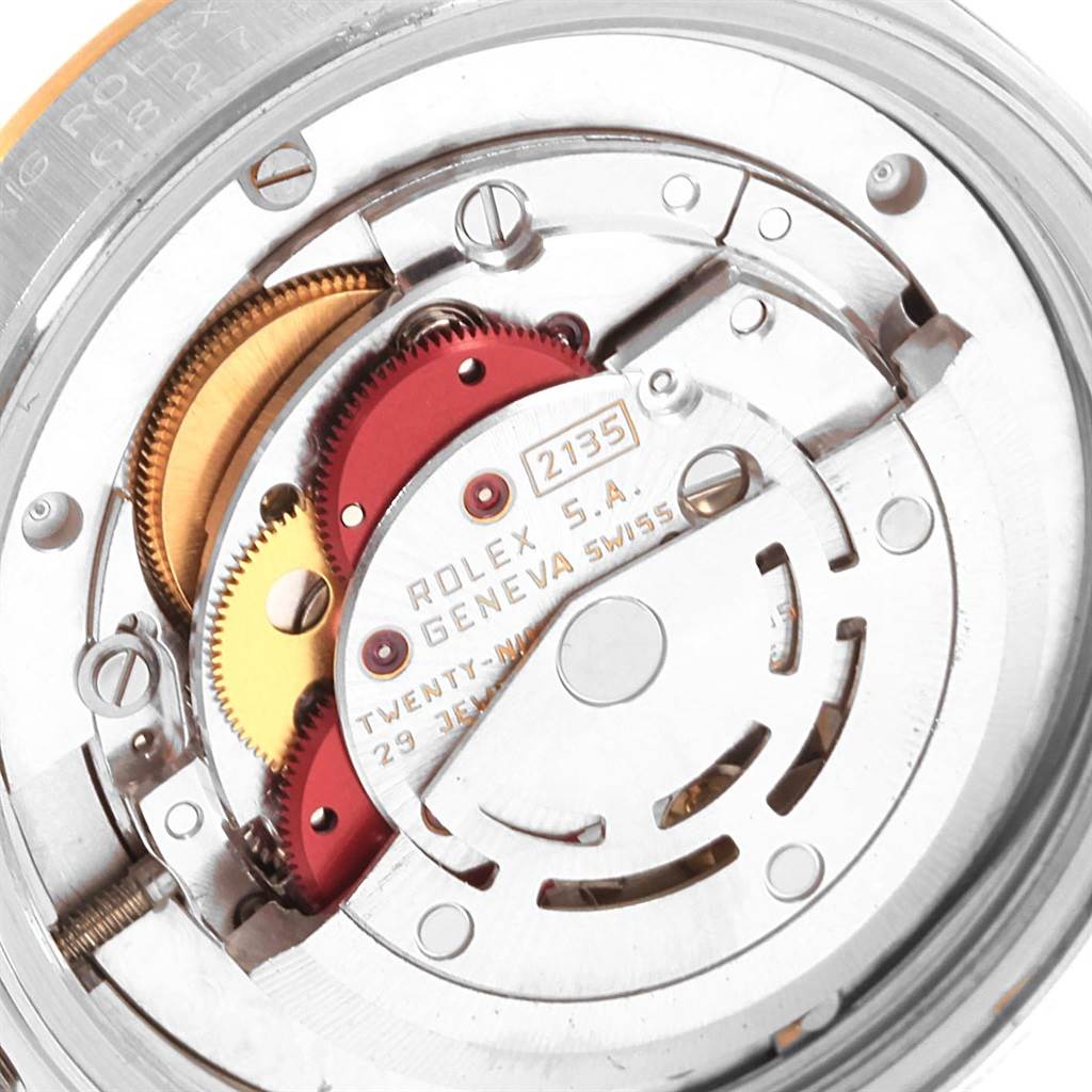 This is an internal close-up of the Rolex Mid-Size 68273 Women's Steel and Gold (two tone) Champagne Dial 68273 Women's Steel and Gold (two tone) Champagne Dial model watch movement, showing its intricate mechanical parts.
