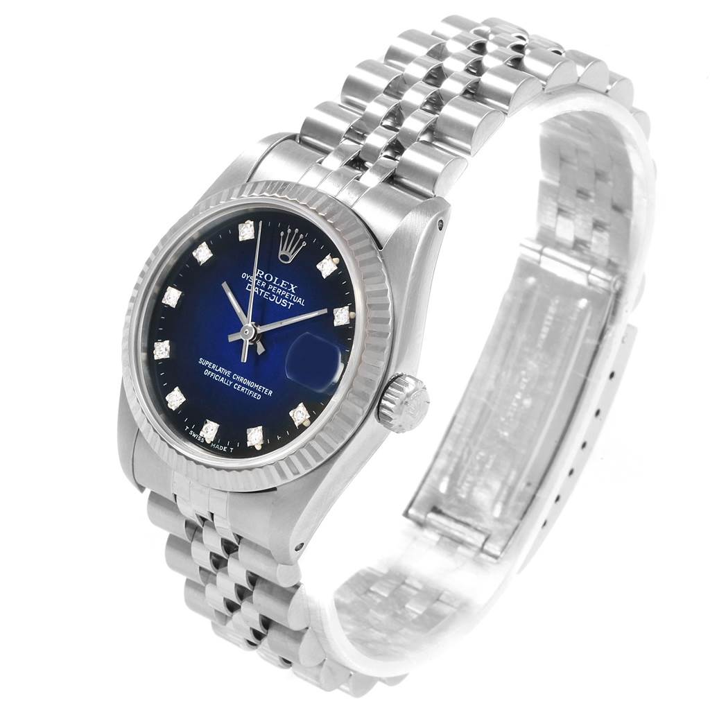 This image shows a Rolex Mid-Size 68274 Women's Stainless Steel Blue Dial 68274 Women's Stainless Steel Blue Dial Datejust watch at an angled view displaying its blue dial, fluted bezel, and Jubilee bracelet.