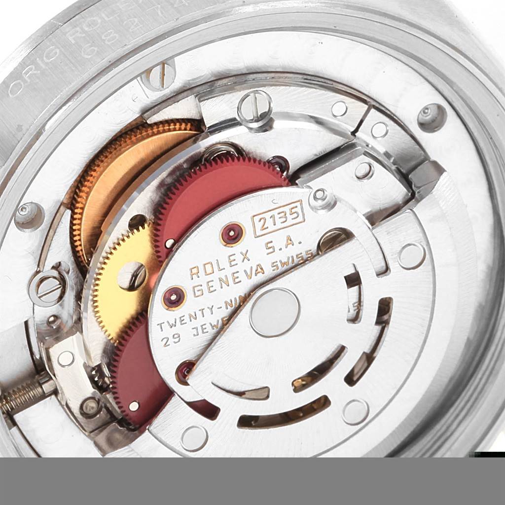 The image shows the internal movement mechanism of a Rolex Mid-Size 68274 Women's Stainless Steel Blue Dial 68274 Women's Stainless Steel Blue Dial model, showcasing gears and components from a close angle.