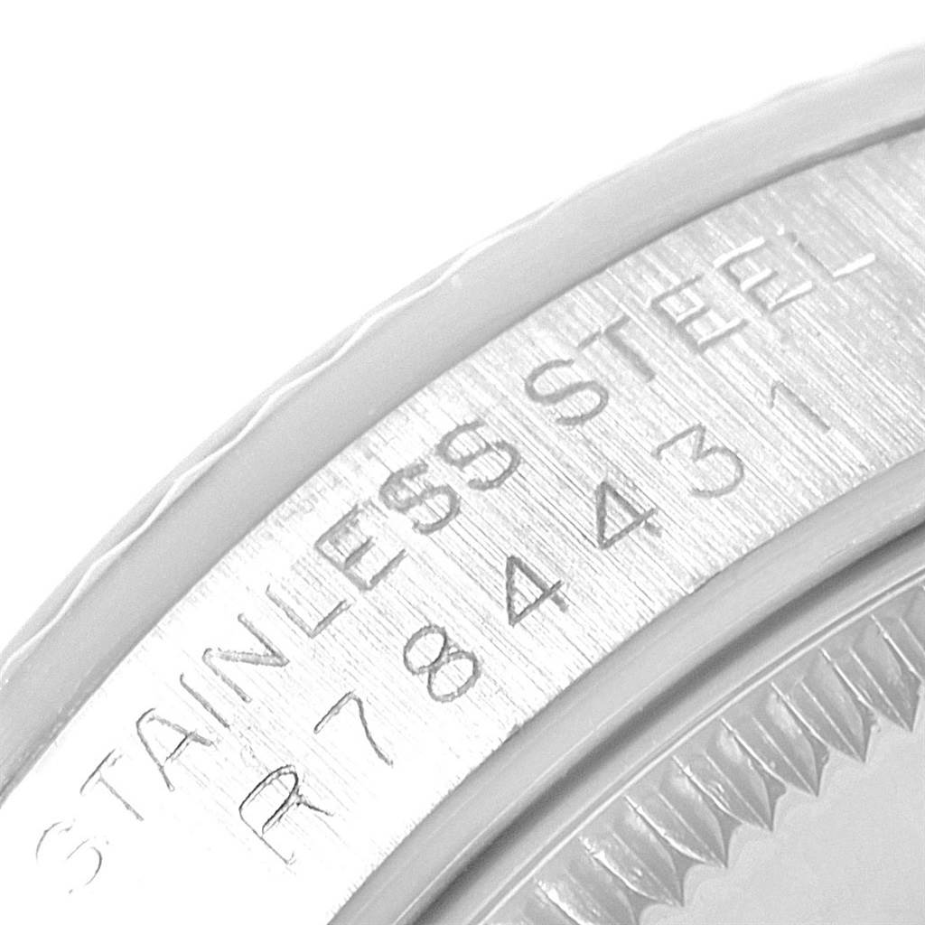 The image shows a close-up of the stainless steel bezel and reference number of a Mid-Size Rolex watch.