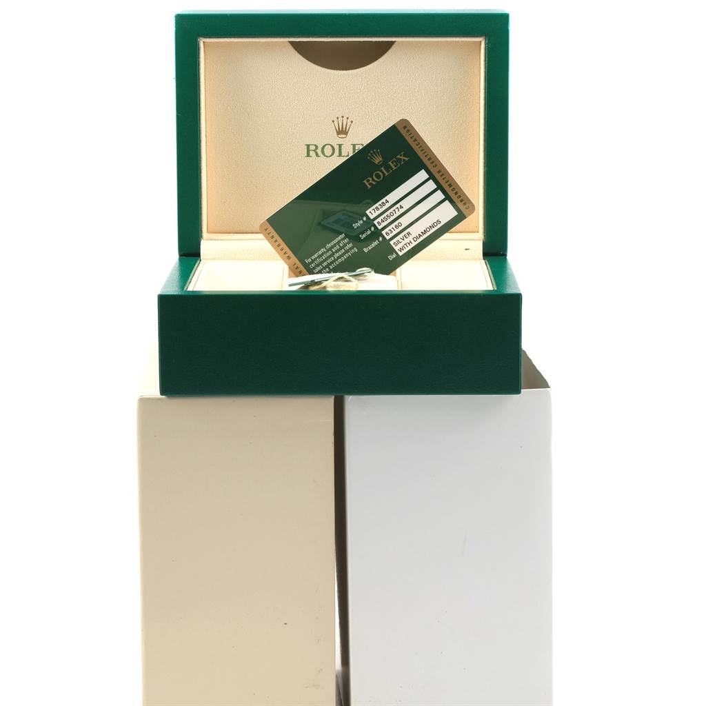 The image shows a green Rolex watch box with an open lid, revealing the interior and a warranty card for a Rolex Mid-Size 178384 Women's Stainless Steel Silver Dial 178384 Women's Stainless Steel Silver Dial model.