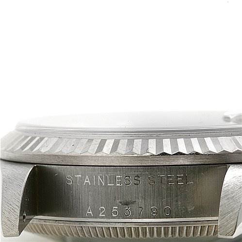 The image shows a close-up side view of a Mid-Size Rolex watch, highlighting the stainless steel casing and serial number.