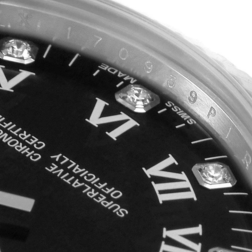 This close-up image shows the dial and part of the bezel of a Mid-Size Rolex watch, highlighting the Roman numerals and diamond markers.