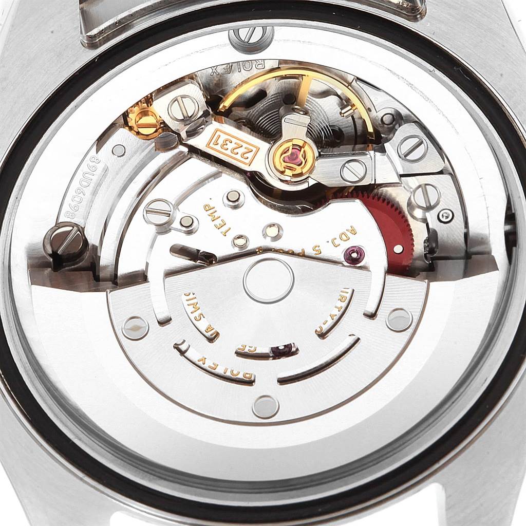 The image shows a close-up view of the inner mechanical movement of a Mid-Size Rolex watch from the back.