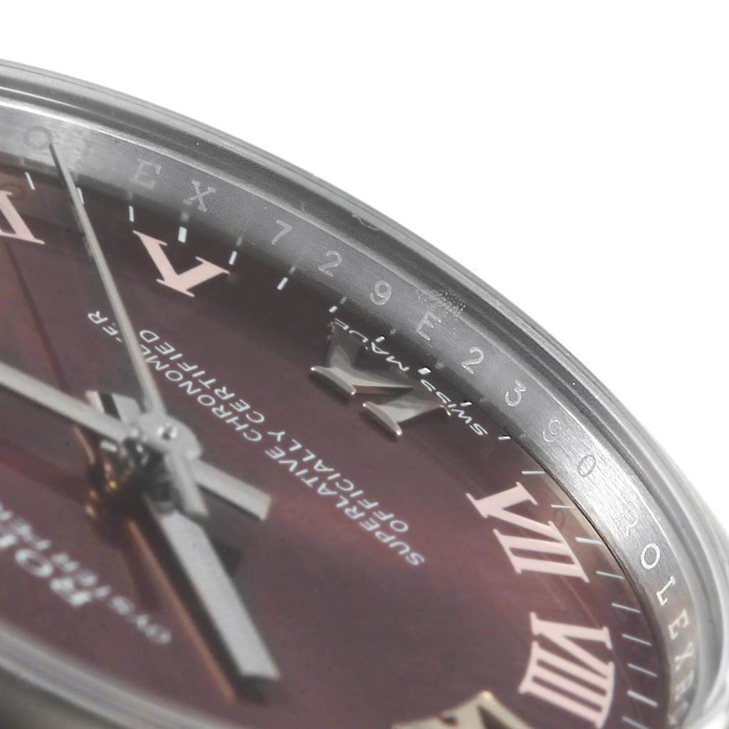 The image shows a close-up angle of the dial and bezel of a Mid-Size Rolex watch, highlighting the roman numerals and logo.