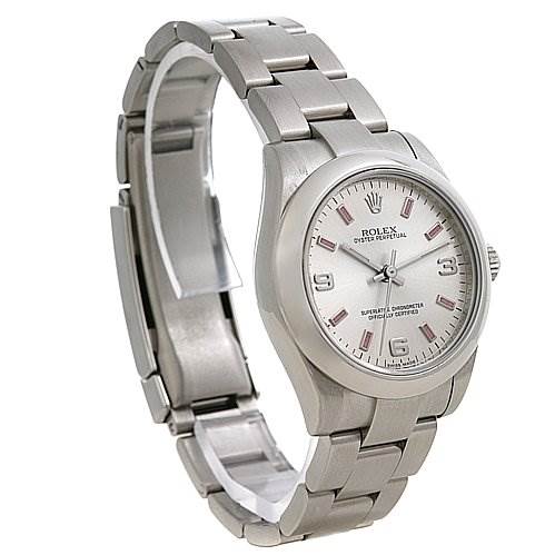 The Mid-Size Rolex watch is shown at a three-quarter angle, displaying the face, band, and crown.