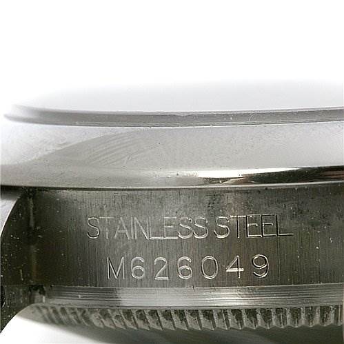 The image shows a close-up of the side casing of a Mid-Size Rolex watch, highlighting its stainless steel material and serial number.