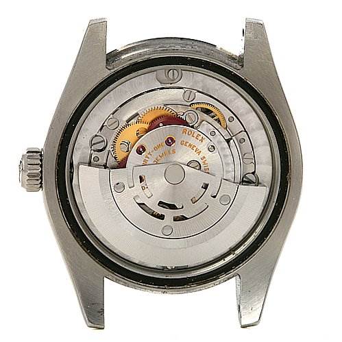 The image shows the back view of a Mid-Size Rolex watch, displaying its mechanical movement and internal components.