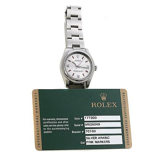 The image shows a top-down view of the Rolex Mid-Size 177200 Women's Stainless Steel Silver Dial 177200 Women's Stainless Steel Silver Dial watch, visible along with its warranty card displaying model information.