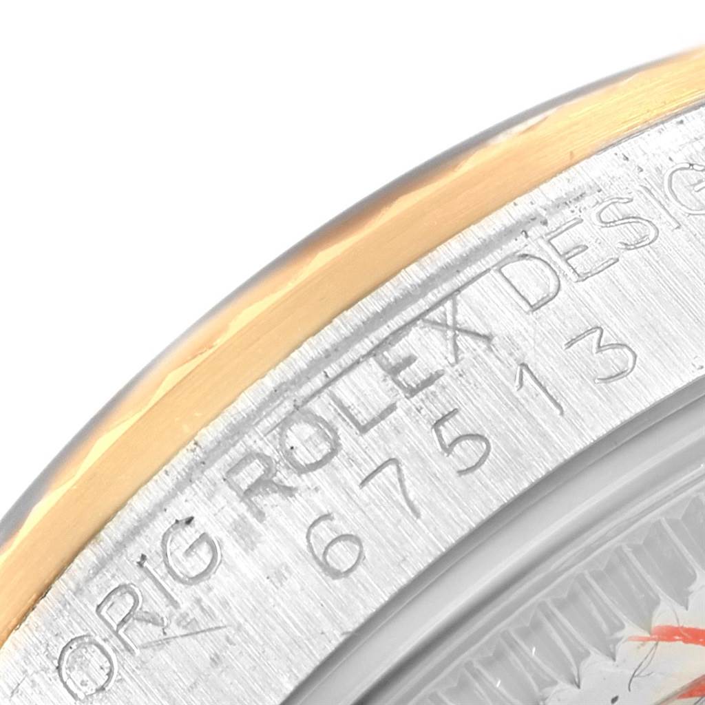 The image shows a close-up of the side of the bezel and case of a Rolex Mid-Size 67513 Women's Steel and Gold (two tone) Champagne Dial 67513 Women's Steel and Gold (two tone) Champagne Dial model, highlighting engraved markings.
