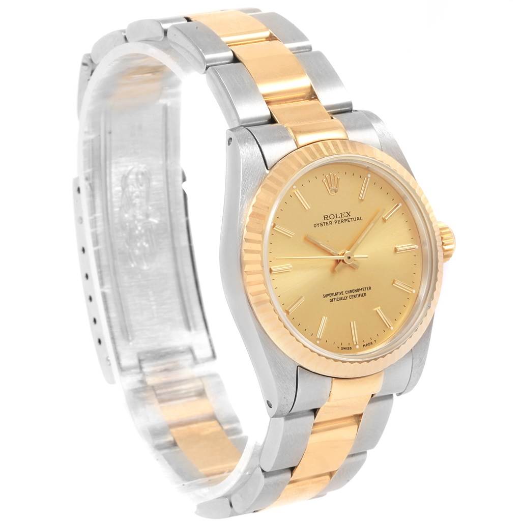 The image shows a Rolex Mid-Size 67513 Women's Steel and Gold (two tone) Champagne Dial 67513 Women's Steel and Gold (two tone) Champagne Dial Oyster Perpetual watch from a three-quarter front angle, highlighting its two-tone bracelet and gold dial.