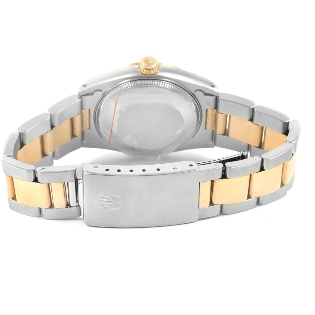 The image shows a rear view of a Rolex Mid-Size 67513 Women's Steel and Gold (two tone) Champagne Dial 67513 Women's Steel and Gold (two tone) Champagne Dial model watch, highlighting its bracelet, clasp, crown, and case back.