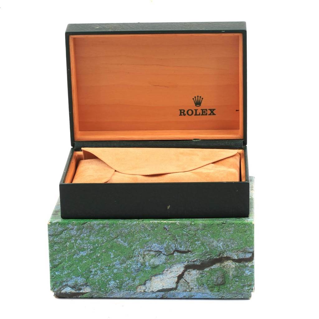 This image shows an open Rolex Mid-Size 67513 Women's Steel and Gold (two tone) Champagne Dial 67513 Women's Steel and Gold (two tone) Champagne Dial watch box, revealing the interior and an unopened pouch inside.