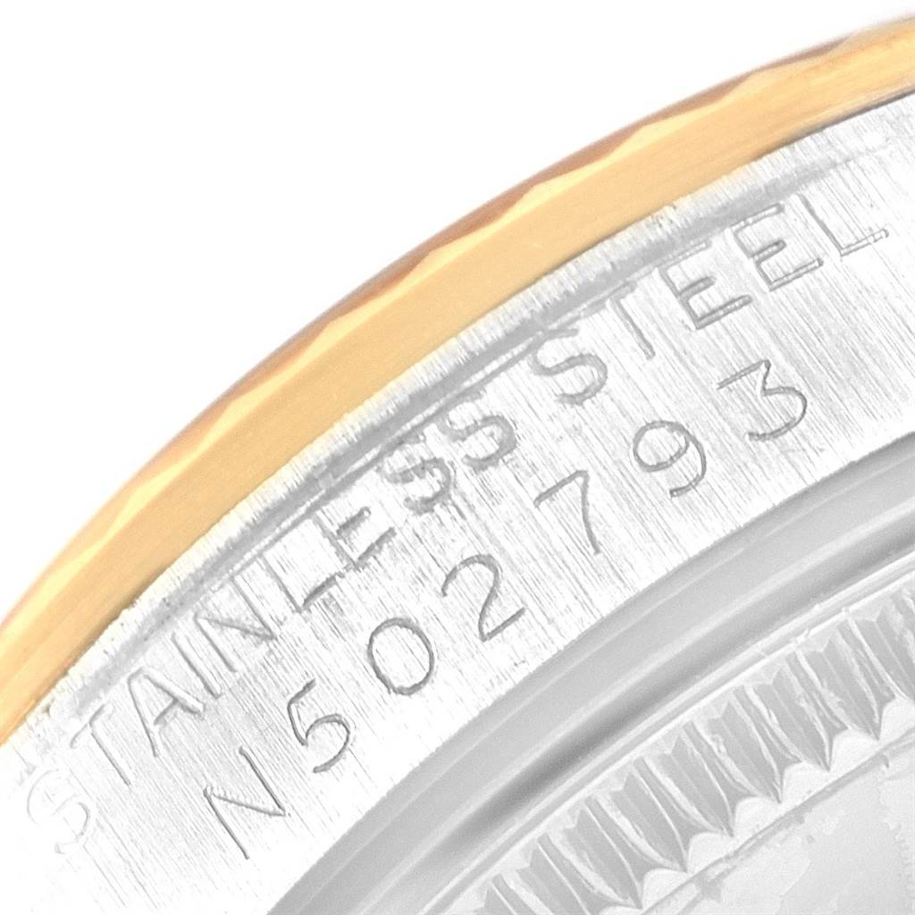 This image shows a close-up angle of the serial number and stainless steel casing of a Mid-Size Rolex watch.