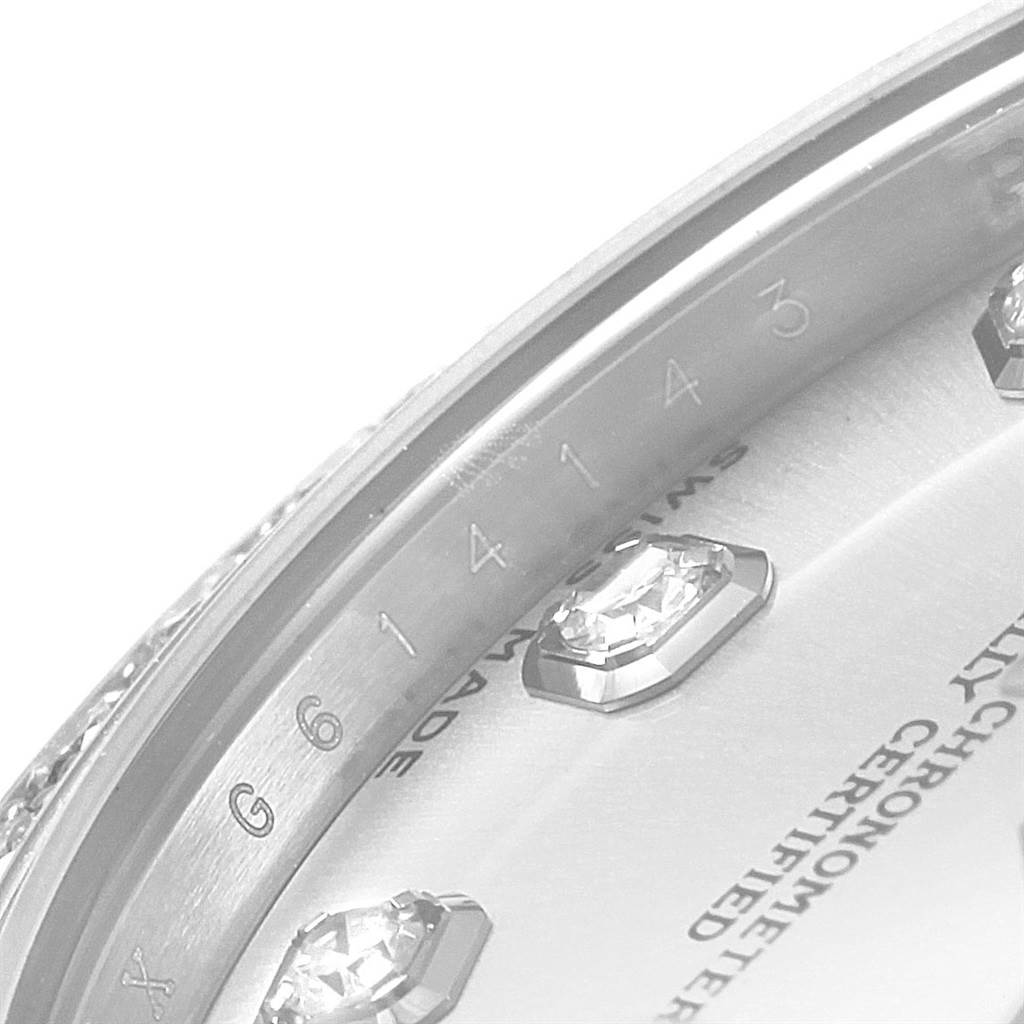 This close-up image of a Rolex Mid-Size 178384 Women's Stainless Steel Silver Dial 178384 Women's Stainless Steel Silver Dial watch shows part of the dial, diamond hour markers, and serial number.
