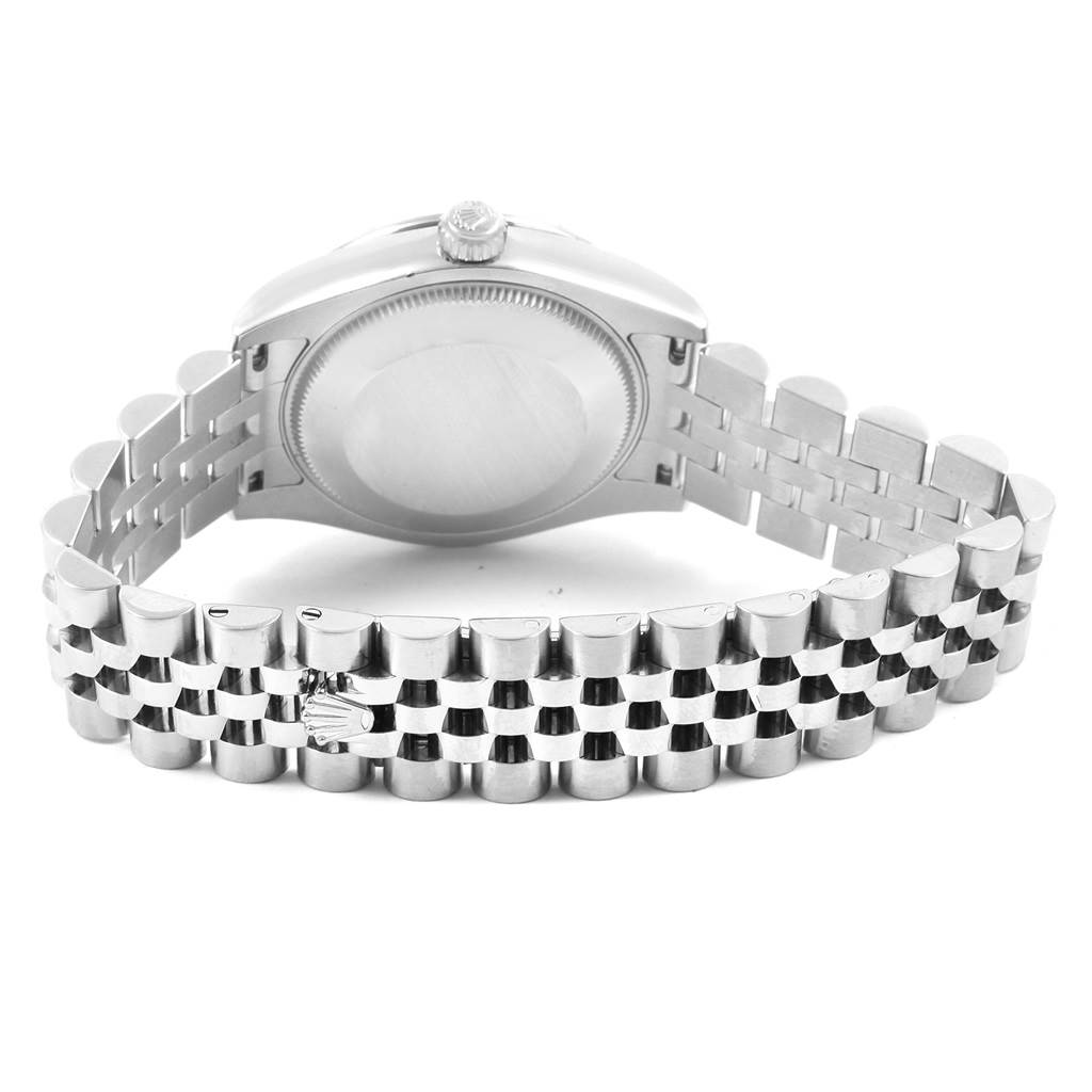 The image shows the back view of a mid-size Rolex watch, focusing on the case back and part of the bracelet.