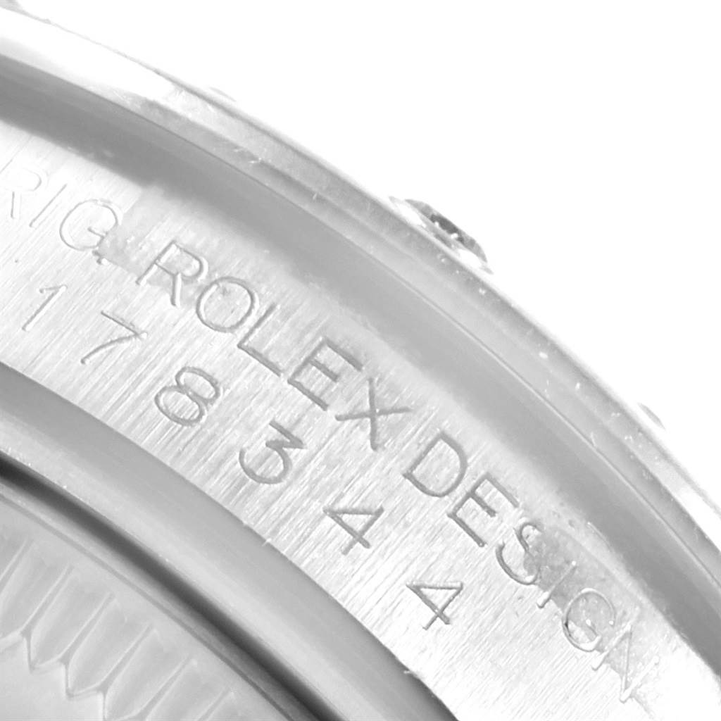 The image shows an extreme close-up of the side-engraving on a Mid-Size Rolex watch, highlighting the model number.