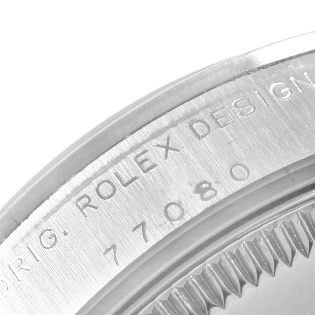 The image shows a close-up of the back case of a Mid-Size Rolex watch, highlighting the engraved text and serial number.