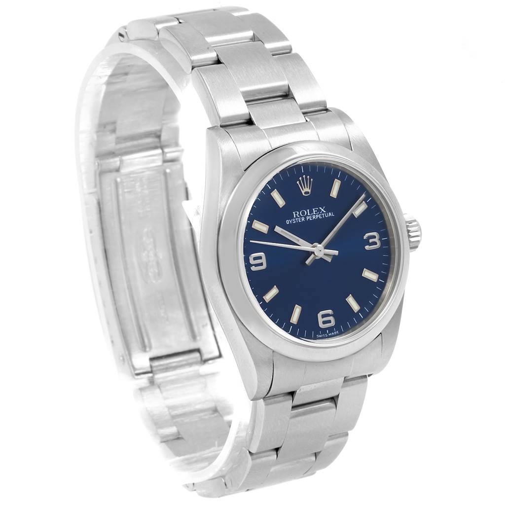 This image shows a Rolex Mid-Size 77080 Women's Stainless Steel Blue Dial 77080 Women's Stainless Steel Blue Dial Oyster Perpetual watch at a three-quarter angle, displaying the bracelet, case, and blue dial.