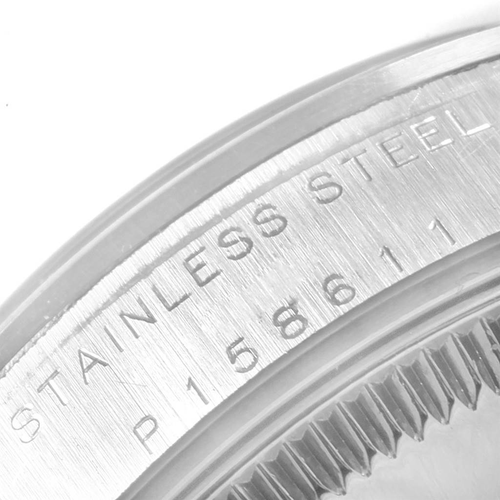 A close-up shot of the case back engraving on a Rolex Mid-Size 77080 Women's Stainless Steel Blue Dial 77080 Women's Stainless Steel Blue Dial model, showing "STAINLESS STEEL" and the serial number.