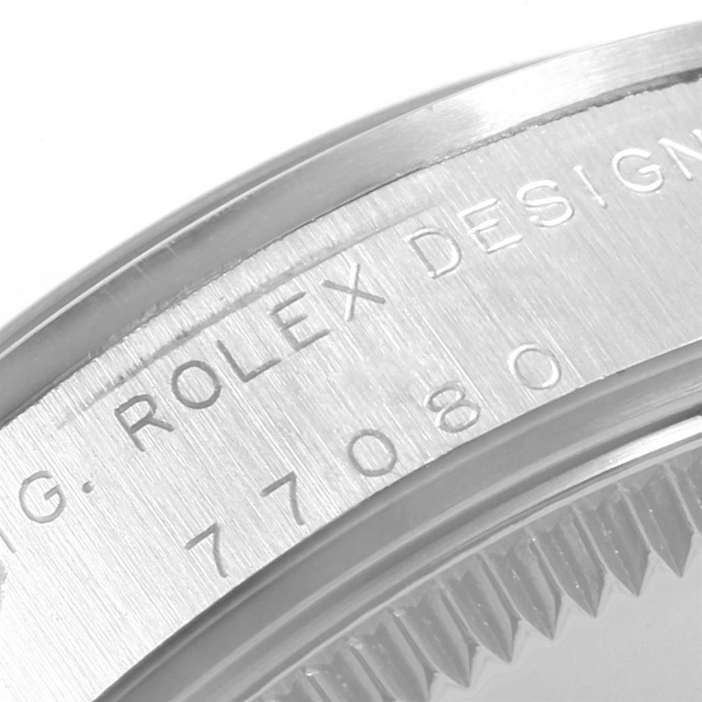 This is a close-up of the engraved case back of a Mid-Size Rolex watch, showing the model number 77080.