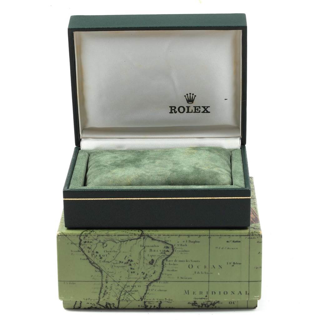 The image shows an open box for a Rolex Mid-Size 77080 Women's Stainless Steel Black Dial 77080 Women's Stainless Steel Black Dial model watch, showcasing the interior cushion and logo.