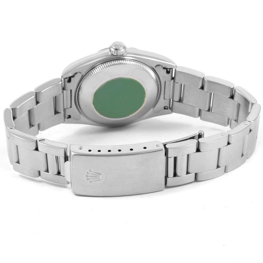 The image shows the back view of a Rolex Mid-Size 77080 Women's Stainless Steel Black Dial 77080 Women's Stainless Steel Black Dial model watch, highlighting the case back and bracelet clasp.