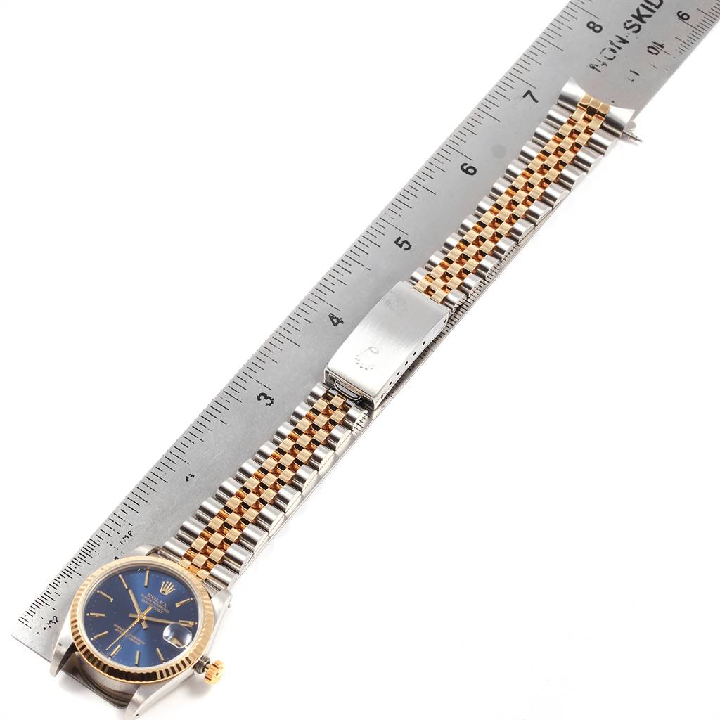 The image shows the full length of a Rolex Mid-Size 68273 Women's Steel and Gold (two tone) Blue Dial 68273 Women's Steel and Gold (two tone) Blue Dial watch, including the face, crown, and band, aligned with a ruler.