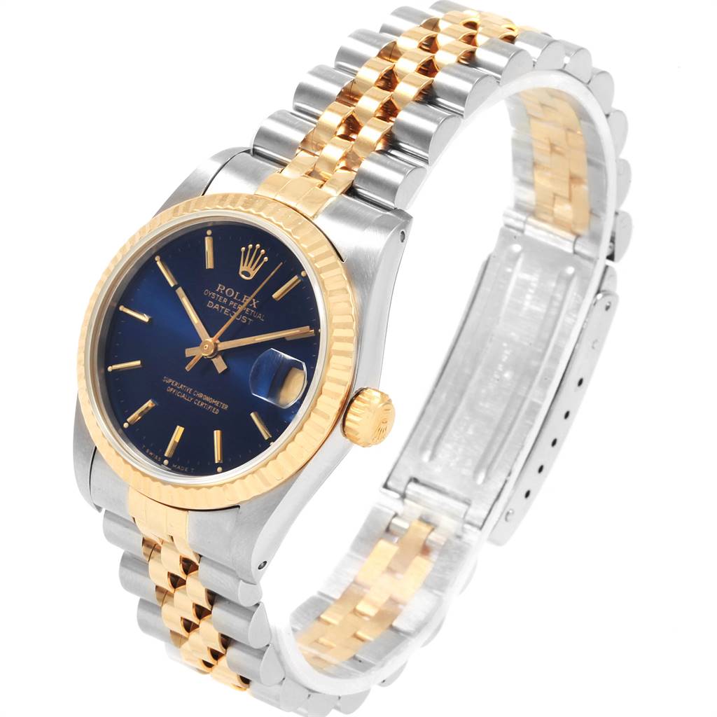 The image shows a Rolex Mid-Size 68273 Women's Steel and Gold (two tone) Blue Dial 68273 Women's Steel and Gold (two tone) Blue Dial model watch at an angle highlighting its blue dial, gold bezel, and two-tone bracelet.