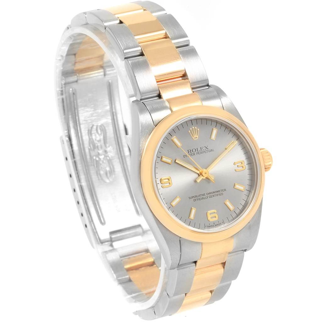 The image shows a Rolex Oyster Perpetual Mid-Size watch angled from the front-left, highlighting the dial, bezel, and two-tone bracelet.