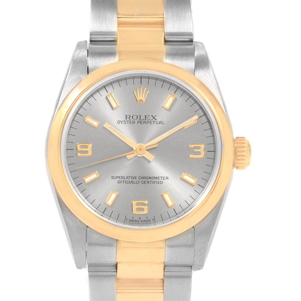 The image shows a Rolex Mid-Size 77483 Women's Steel and Gold (two tone) Grey Dial 77483 Women's Steel and Gold (two tone) Grey Dial Oyster Perpetual watch face and part of the bracelet in a frontal view.