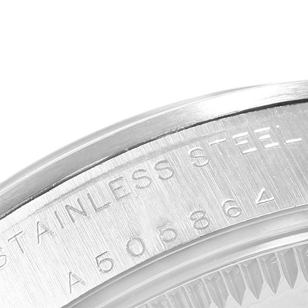 The image shows a close-up of the stainless steel case back with engraved serial numbers of a Mid-Size Rolex watch.