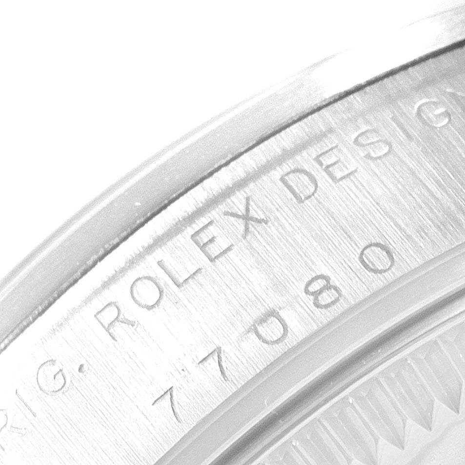 The image shows a close-up of the case back engraving on a Rolex Mid-Size 77080 Women's Stainless Steel Silver Dial 77080 Women's Stainless Steel Silver Dial model watch.