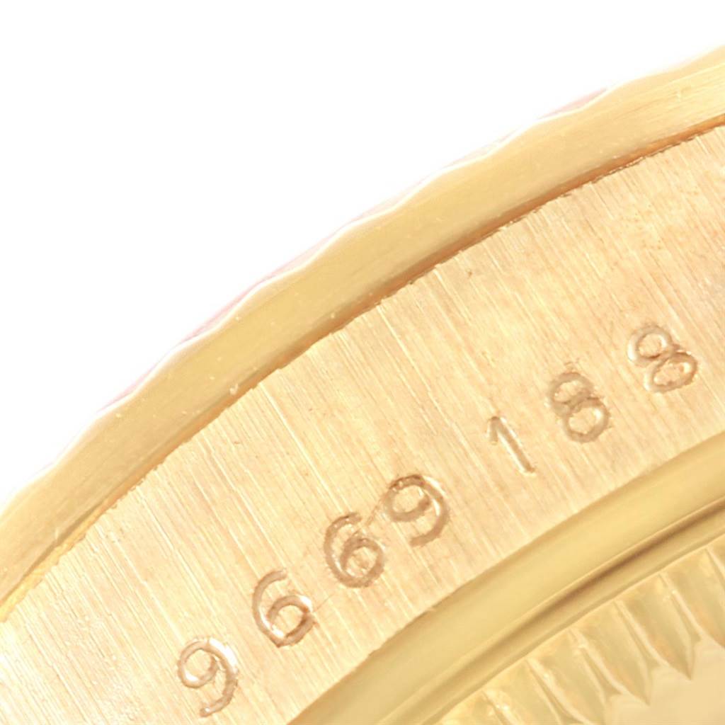 This close-up shows the side of the bezel and part of the engraved serial number on a Rolex Mid-Size 68278 Women's Yellow Gold Silver Dial 68278 Women's Yellow Gold Silver Dial model watch.
