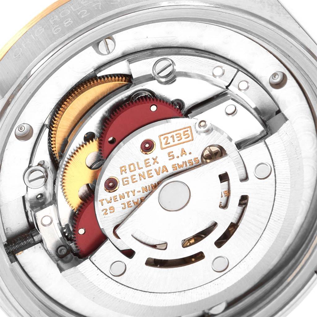 This close-up image shows the intricate inner mechanisms of a Mid-Size Rolex watch model 2135.