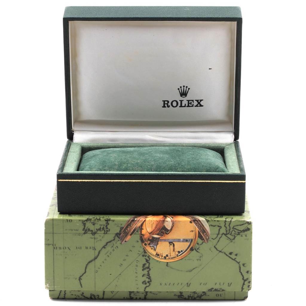 The image shows the opened box of a Rolex Mid-Size 68273 Women's Steel and Gold (two tone) Champagne Dial 68273 Women's Steel and Gold (two tone) Champagne Dial watch, highlighting the inner cushion and outer box with a map design.