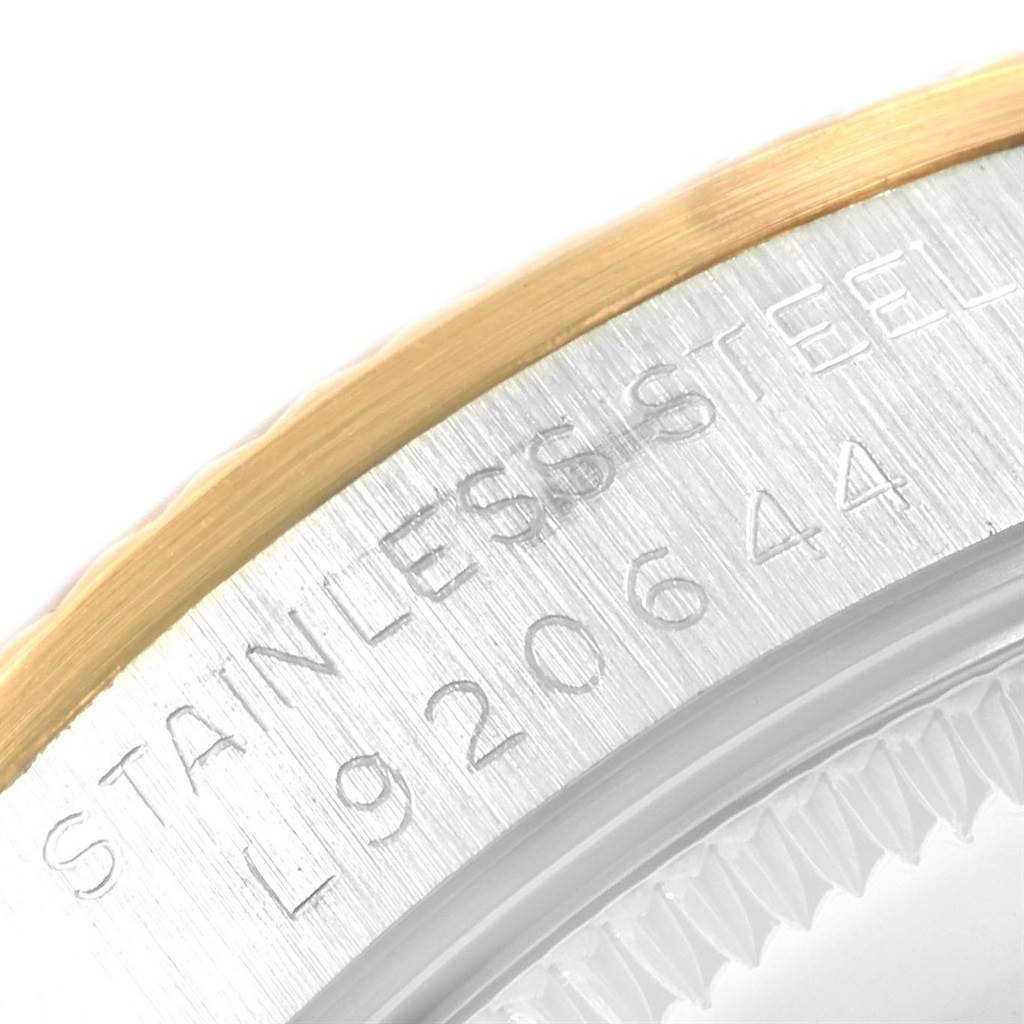 The image shows a close-up of the serial engraving on the stainless steel case back of a Mid-Size Rolex watch.