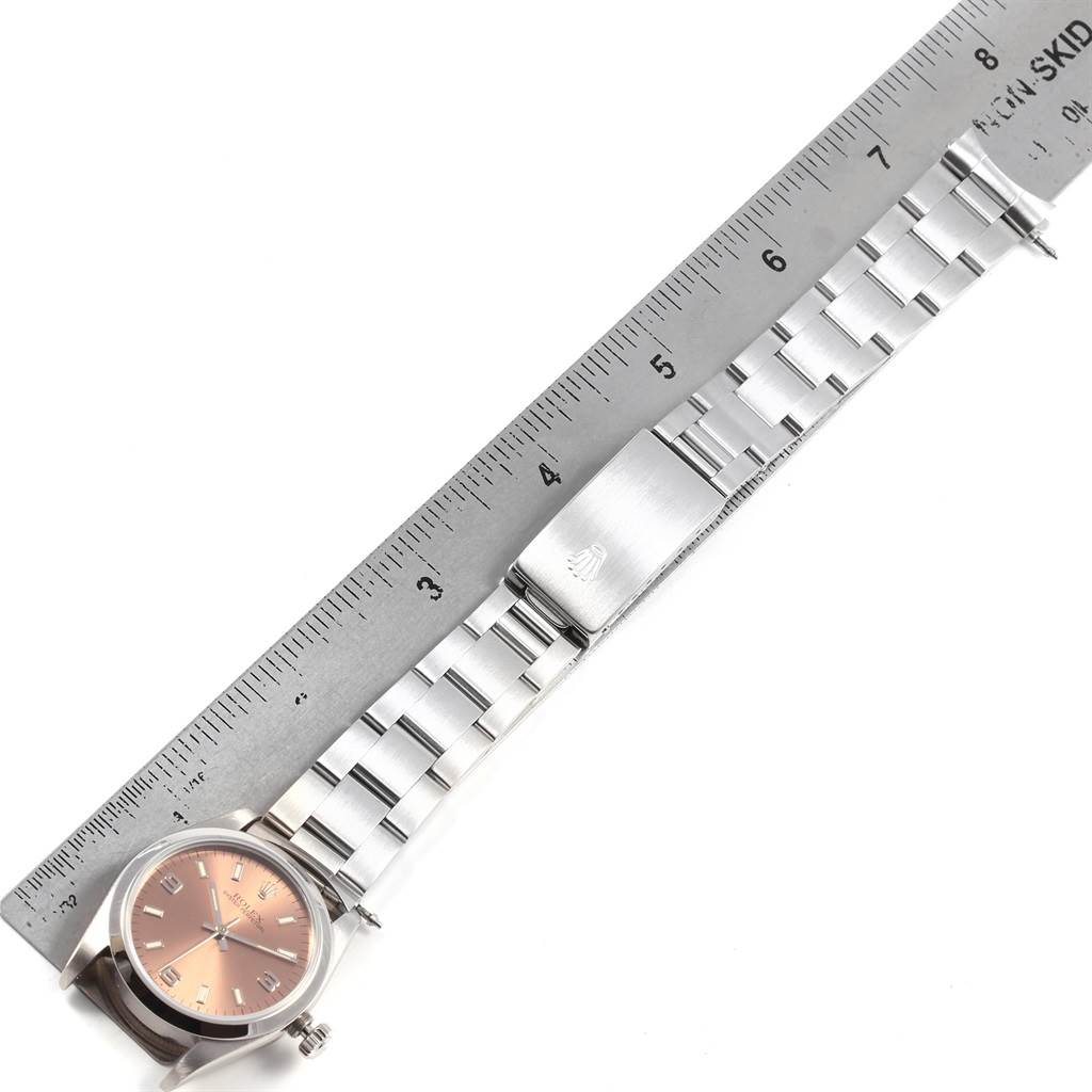 The image shows a Rolex Mid-Size 67480 Women's Stainless Steel Pink Dial 67480 Women's Stainless Steel Pink Dial watch laid flat with its entire band next to a ruler for size reference.