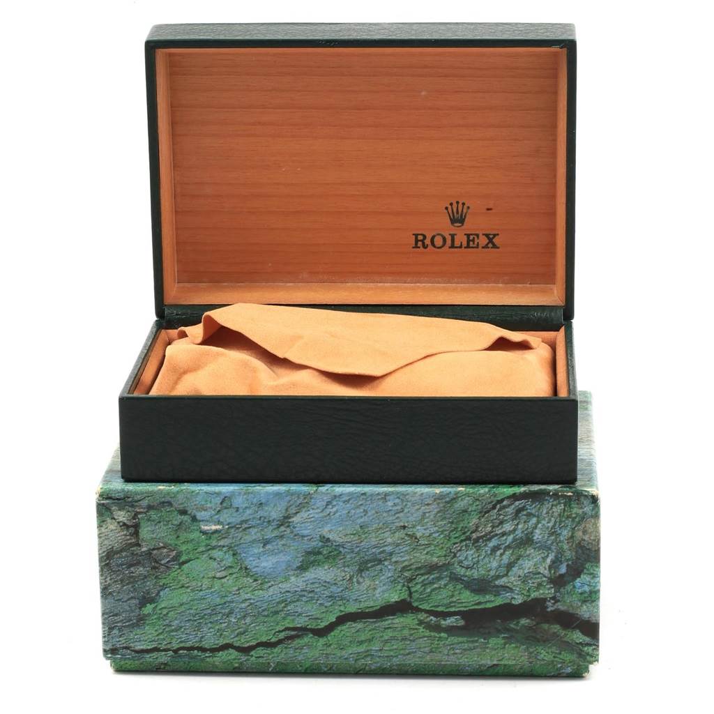 The image shows an open Rolex watch box with orange lining, but the Mid-Size model watch itself is not visible.