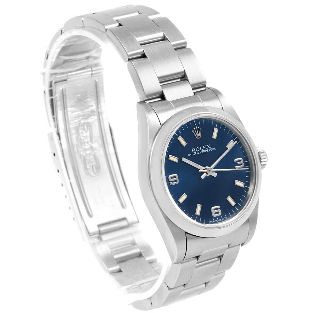 This image shows a side angle of a Rolex Mid-Size 67480 Women's Stainless Steel Blue Dial 67480 Women's Stainless Steel Blue Dial model watch, displaying the face, bezel, crown, and part of the bracelet.