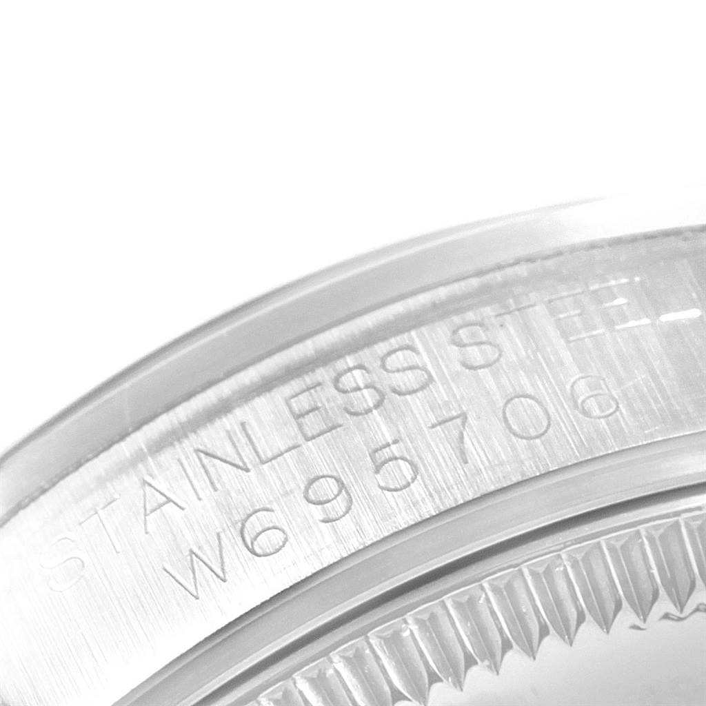 The image shows a close-up of the side of a Mid-Size Rolex watch case, highlighting the engraved serial number.