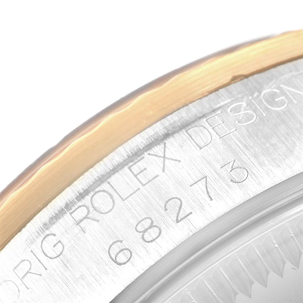 This image shows a close-up of the case back of a Mid-Size Rolex watch, highlighting the branding and serial numberengraving.