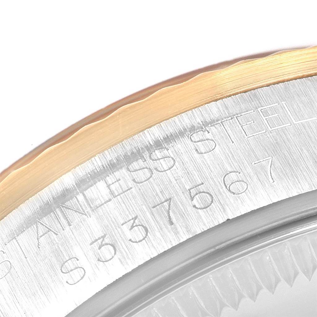 This close-up image shows the engraved stainless steel case back edge of a mid-size Rolex watch.